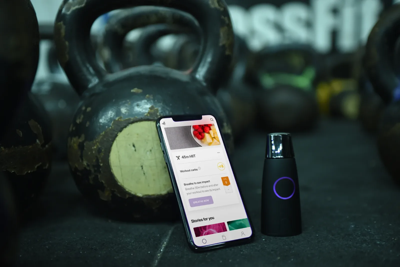 The Lumen metabolic breath device next to its app